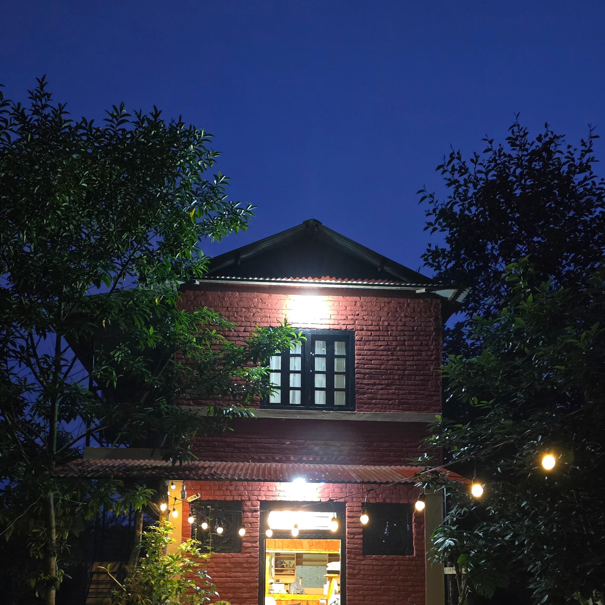 Cozy room with soft lighting and wooden décor Balcony seating overlooking the hills