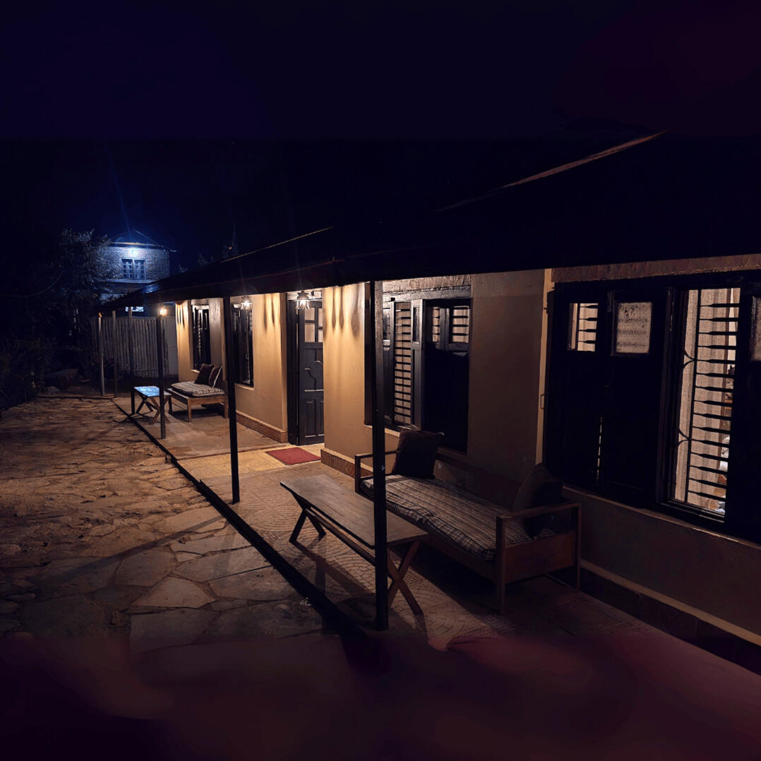 Chalet bedroom with large windows and hill views Mountain view room with sunrise-facing balcony